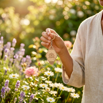 Woman holding personalized wooden keychain engraved with custom logo in a garden